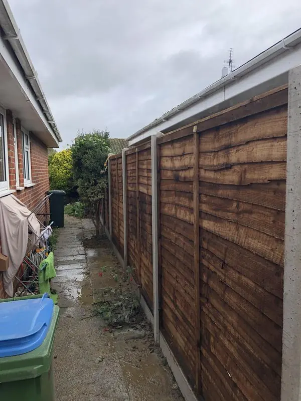 Lap (waney edge) panels on concrete posts and concrete gravel boards
